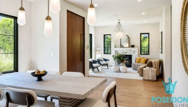 A professional project manager from Poseidon Remodeling reviewing 3D floor plans with a client in a modern Temecula kitchen, highlighting Why Temecula Homeowners Choose Poseidon Remodeling.