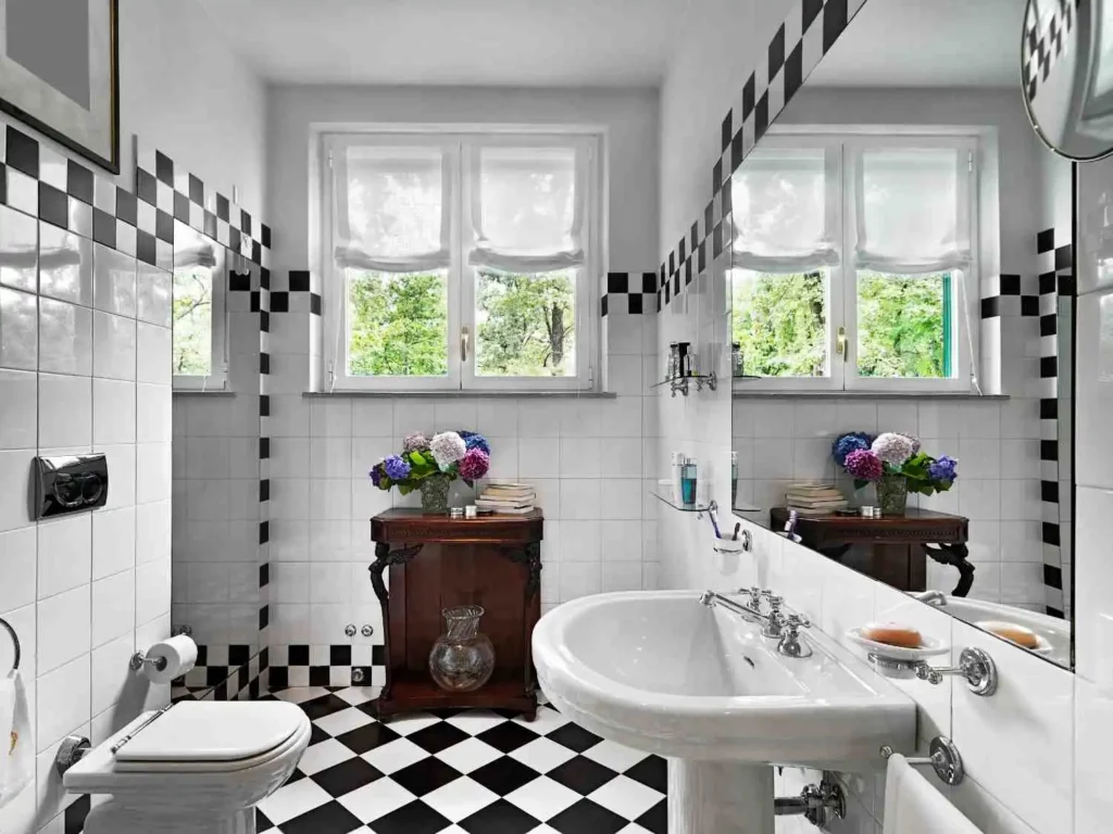 Black and White Bathroom Ideas with checkered floor tiles, white walls, and vintage wooden vanity