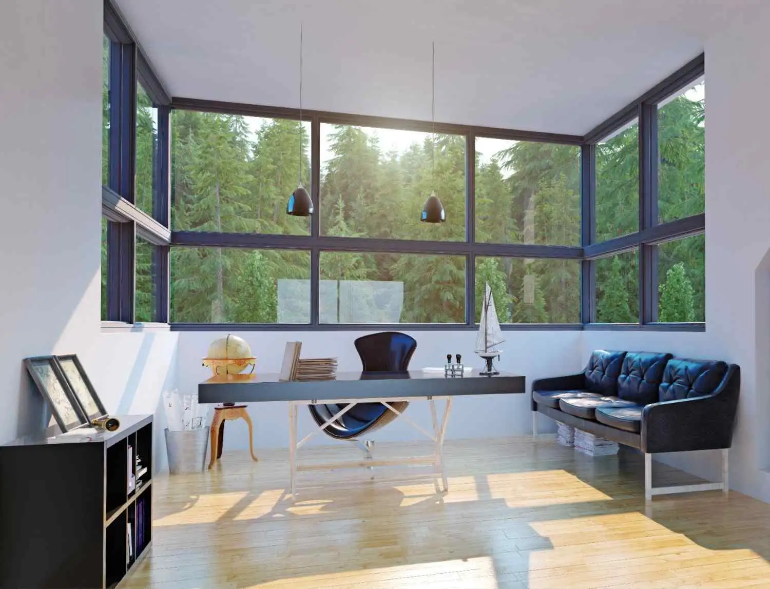 A modern home office featuring floor-to-ceiling panoramic corner windows overlooking a lush green forest, flooding the room with natural light.
